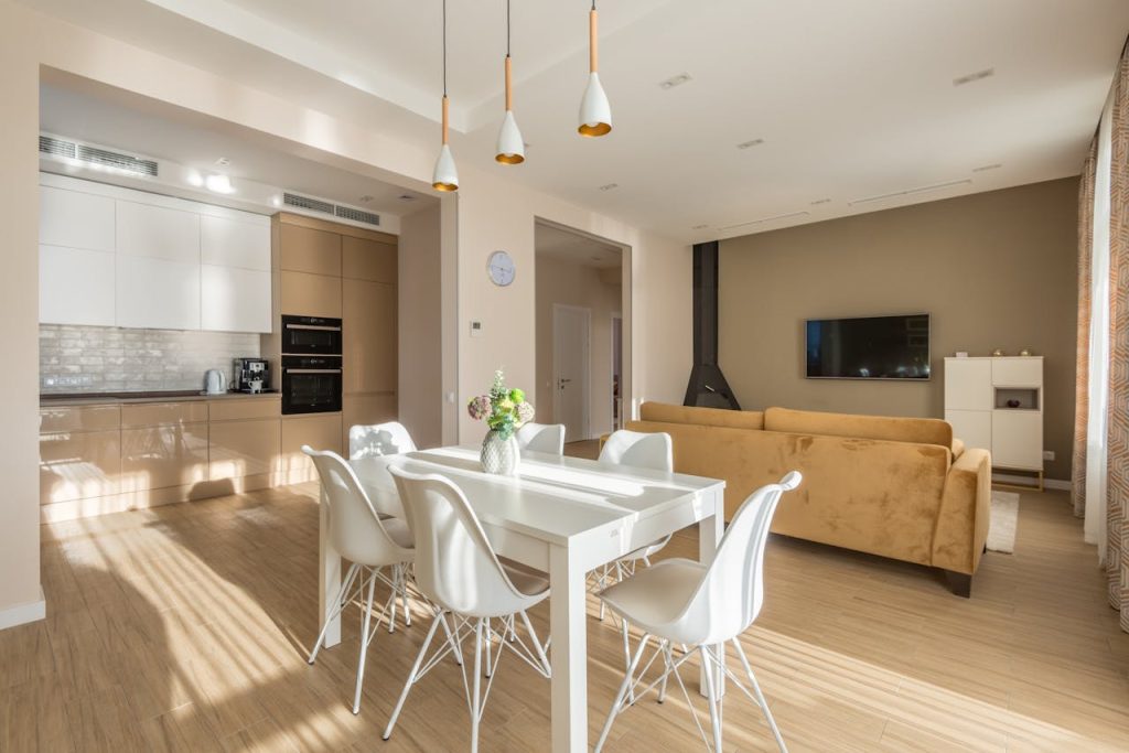 pexels-photo-7546715 Spacious living room and kitchen with modern design and natural lighting.